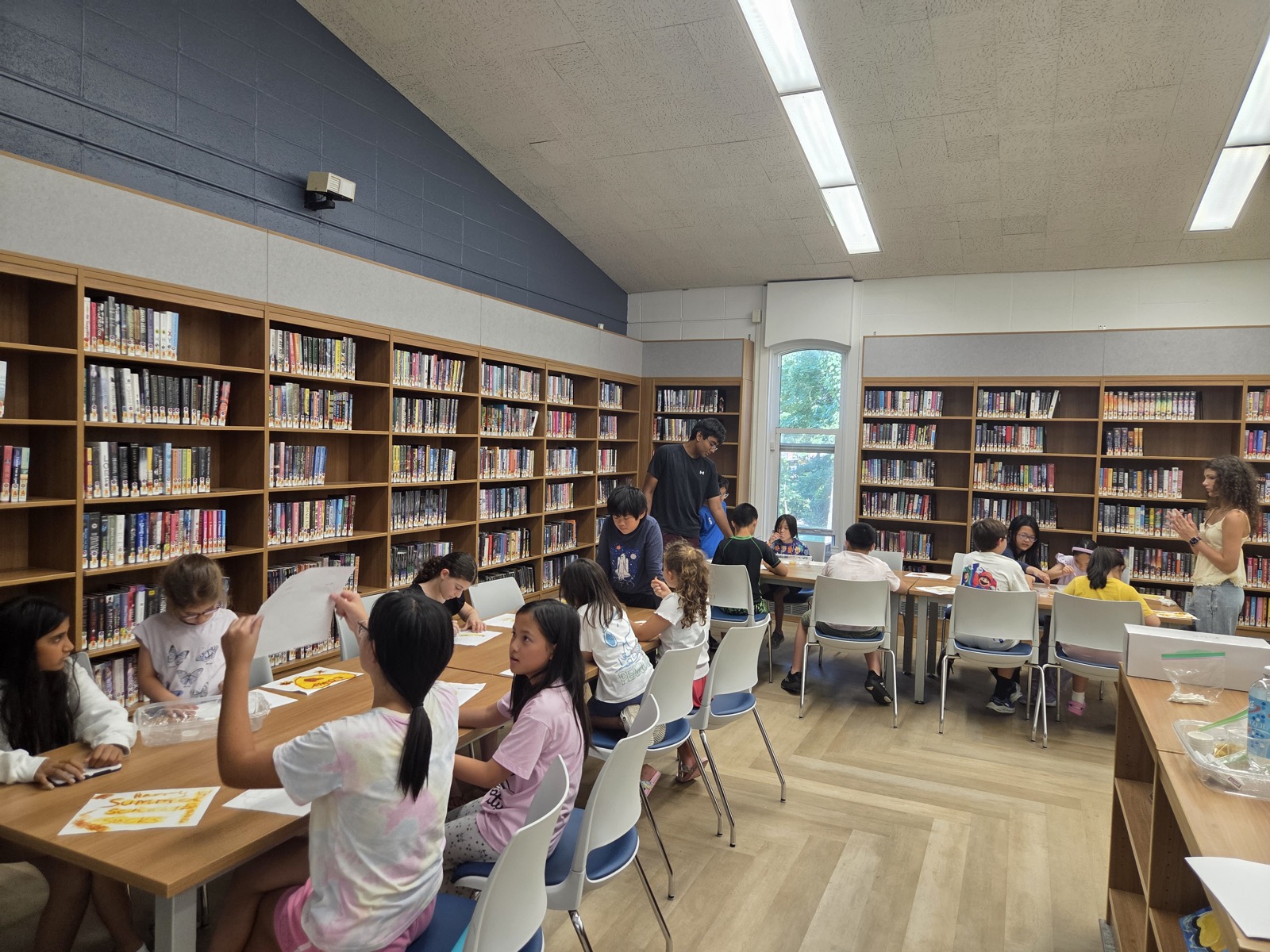 Instructor helping students uncover their secret invisible ink messages